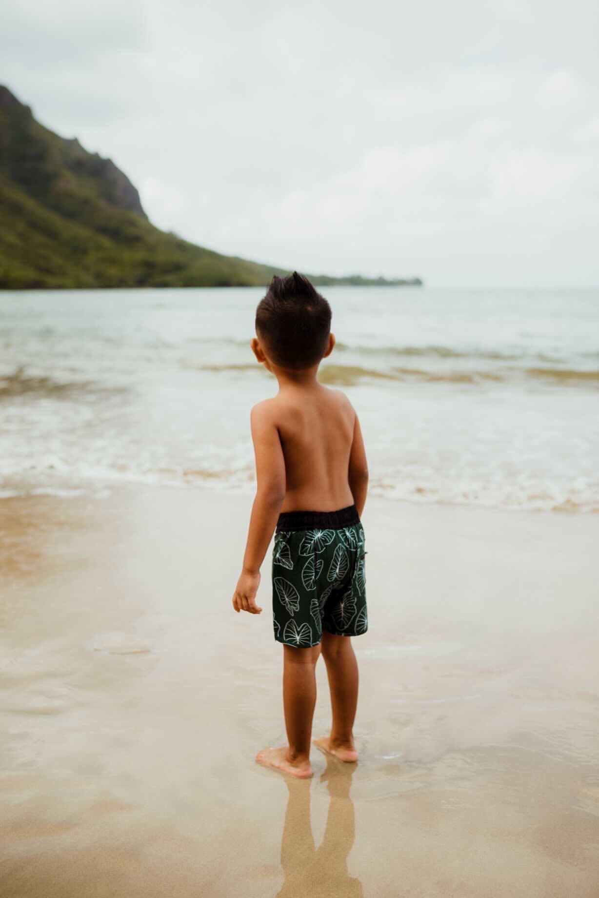 keanu wearing the keiki dept signature green kalo boardshort