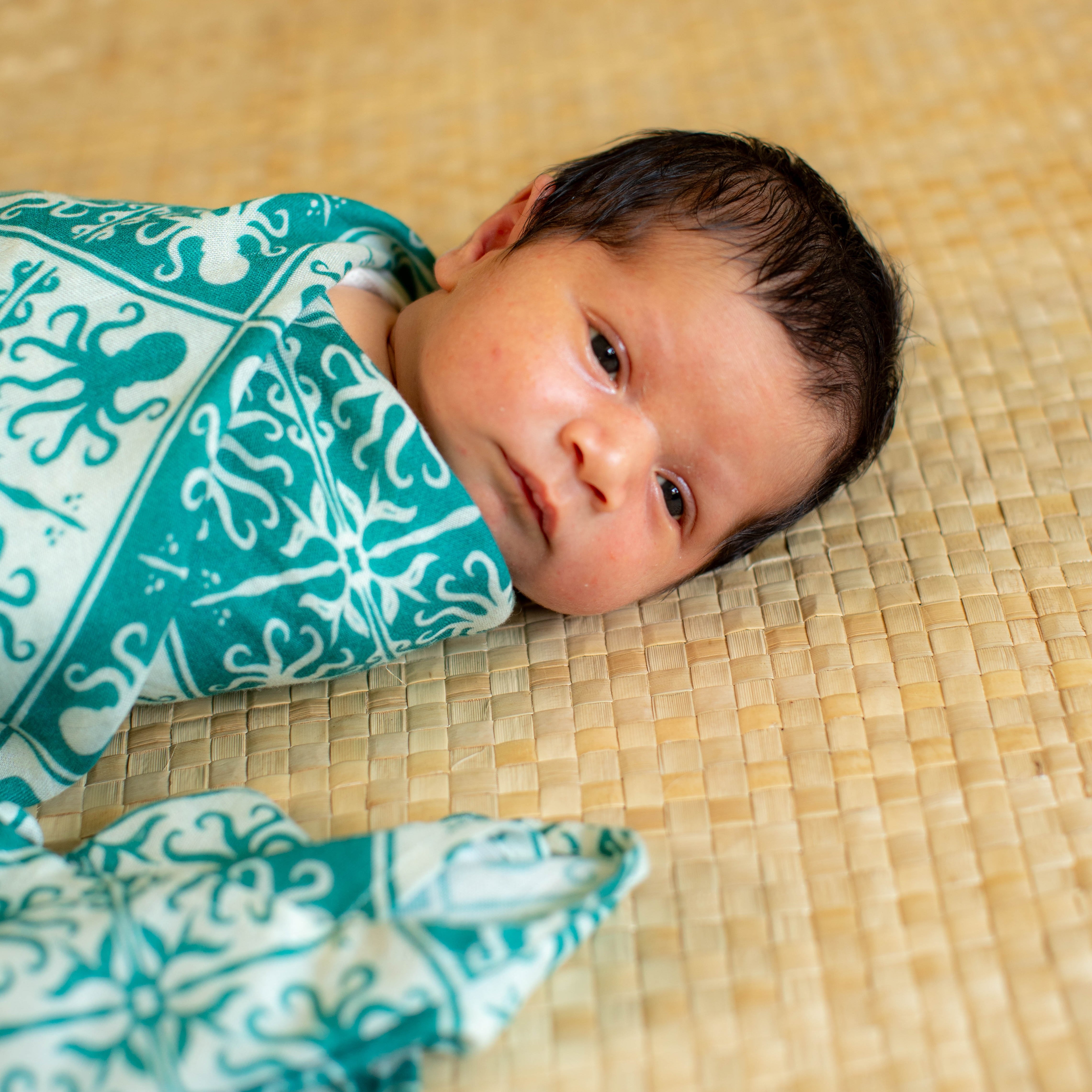 The Keiki Dept Teal Kuiki Heʻe Bamboo Muslin Swaddle Blanket